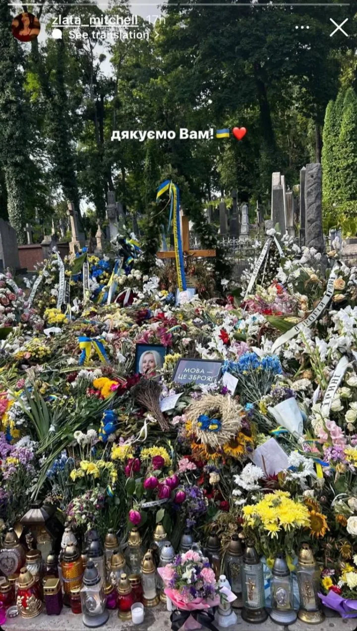 a cemetery with flowers and a cross